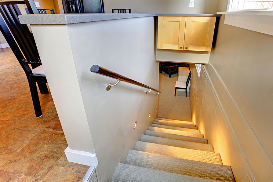 Basement stairs with handrail and spotlights