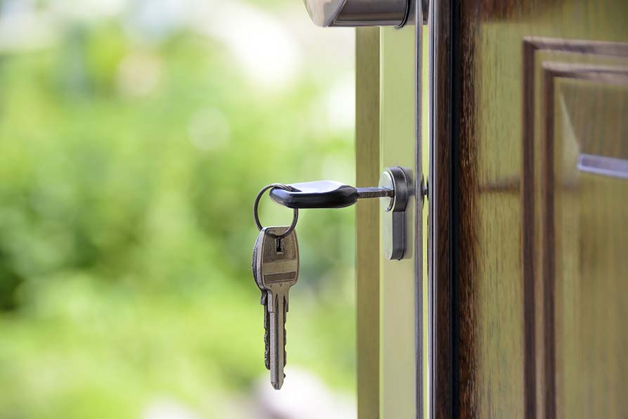 Set of keys in the front door of a new home