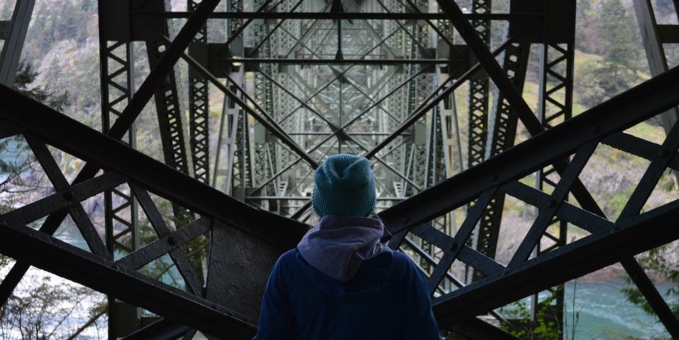 Person standing in front of large metal structure