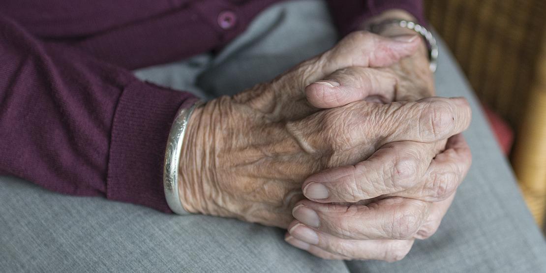 Old person's hands clasped