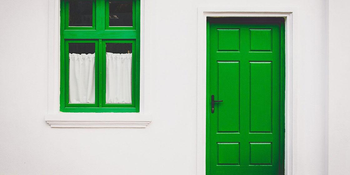 Energy efficient home with a green door and window