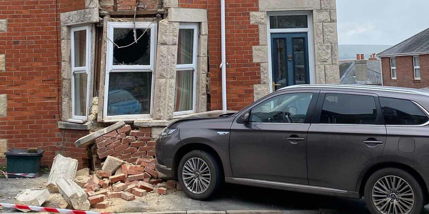 car crashing into a house