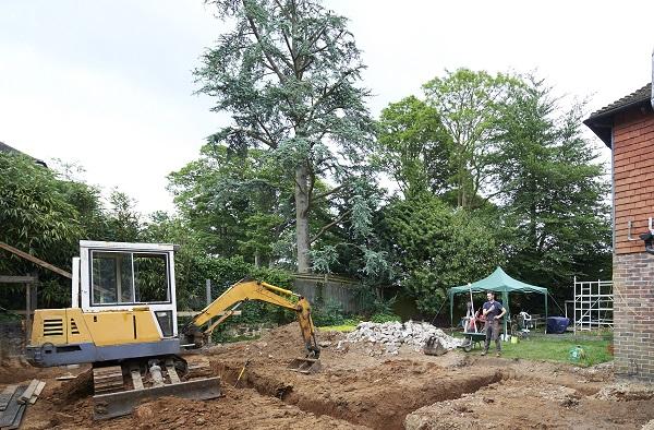 Digger digging into foundations on clay soil