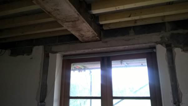 Timber beam with point load on ceiling above window