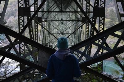 Person standing in front of large metal structure