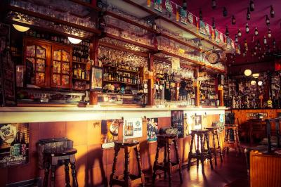 Pub interior - view of the bar, drinks and stools