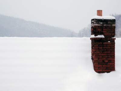 Chimney on a roof with snow